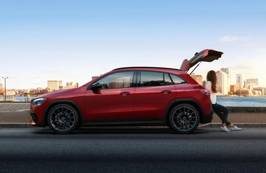 Red Mercedes SUV with person loading items